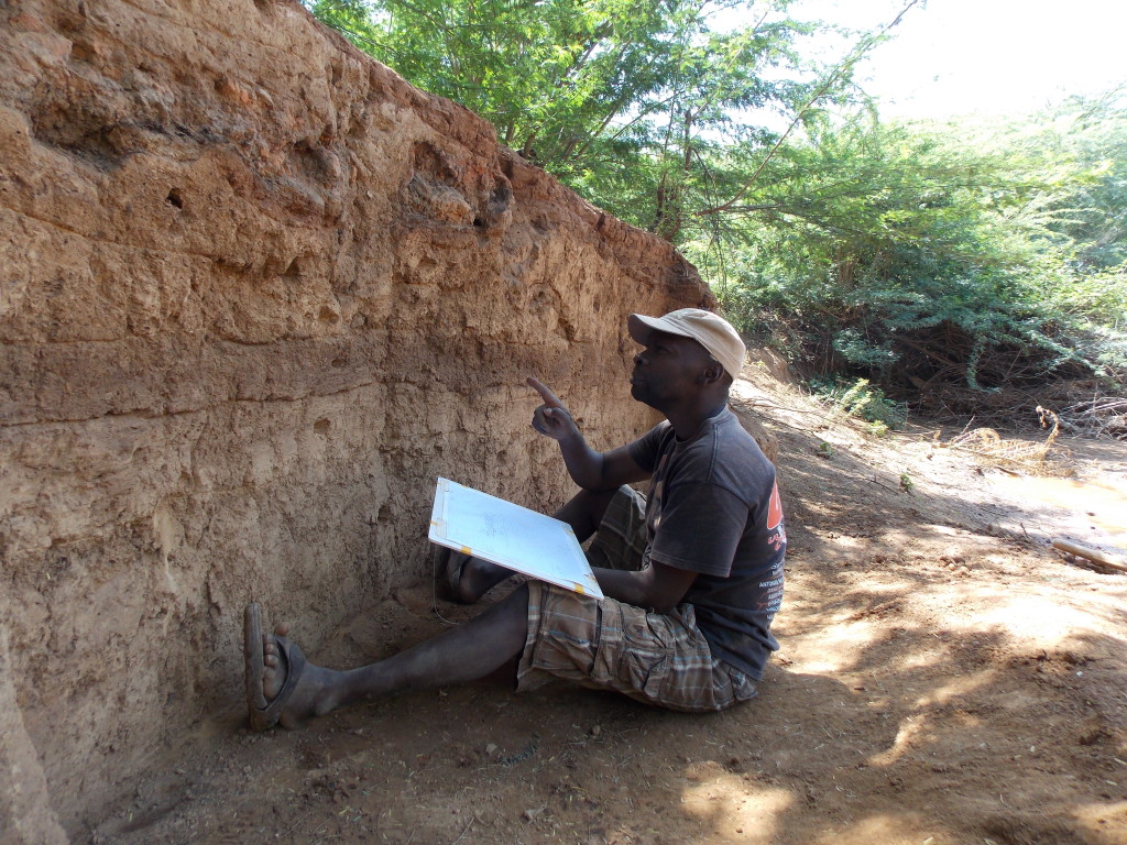 Victor studies the stratigraphy as we finished the excavation